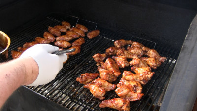 SmokingPit.com - Kentucky Bourbon Glazed Chicken Wings.  Slow cooked on the yoder YS640. Mopping on the bourbon sauce..
