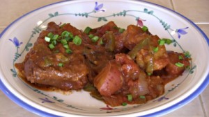 SmokingPit.com - Dutch oven Swiss Steak cooked in a Lodge 12" dutch oven in my Scottsdale Santa Maria style cooker. The Swiss Steak Money Shot.