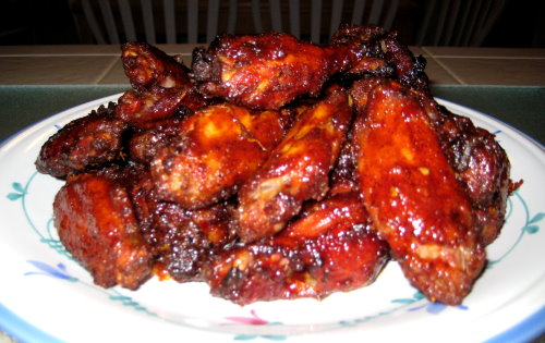 SmokingPit.com - DA Bomb Hot Tiger Sauced party wings smoked over hickory. Chicken at its best!