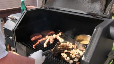 SmokingPit.com -Alaskan King Crab legs & Shrimp on Flat Iron Steaks topped with mushrooms and a Cajun butter sauce. Cookied on the Yoder YS640 smoker & Traeger texas grill. - Grilling and griddle work.