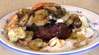 SmokingPit.com -Alaskan King Crab legs & Shrimp on Flat Iron Steaks topped with mushrooms and a Cajun butter sauce. Cookied on the Yoder YS640 smoker & Traeger texas grill. -  Plated up!