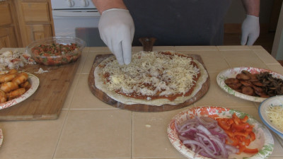 SmokingPit.com - Cajun Seafood Pizza recipe wood fire cooked on my Scottsdale Santa Maria style cooker. Adding mozzarella.