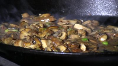 SmokingPit.com - The Colosal Mushroom & Swiss stuffed burger cooked over a oak wood fire on the Scottsdale Santa Maria style pit by Arizona BBQ Outfitters. Cooking on cast iron.