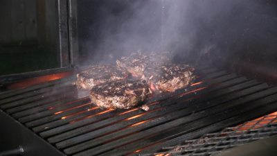 SmokingPit.com - The Colosal Mushroom & Swiss stuffed burger cooked over a oak wood fire on the Scottsdale Santa Maria style pit by Arizona BBQ Outfitters. Grilling the burgers Santa Maria Style.