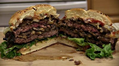 SmokingPit.com - The Colosal Mushroom & Swiss stuffed burger cooked over a oak wood fire on the Scottsdale Santa Maria style pit by Arizona BBQ Outfitters. The money shot!