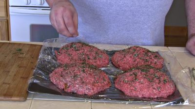 SmokingPit.com - The Colossal Trinity BBQ Surf & Turf burger - stuffed burger cooked over a oak wood fire on the Yoder YS640 Pellet cooker.- Seasoning the burgers.