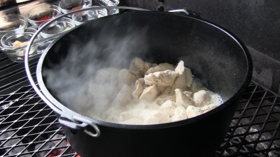 SmokingPit.com - Dutch oven Arroz Con Pollo cooked in a Lodge 12" dutch oven in my Scottsdale Santa Maria style cooker. Browning the chicken breast.