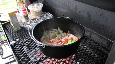 SmokingPit.com - Dutch oven Arroz Con Pollo cooked in a Lodge 12" dutch oven in my Scottsdale Santa Maria style cooker. Cooking the veggies.