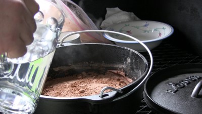 SmokingPit.com - Dutch oven Chocolate Pudding Cake cooked in a Lodge 10" dutch oven in my Scottsdale Santa Maria style cooker. Mixing the chocolate mix.