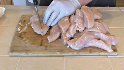 SmokingPit.com - Garlic Parmesan Chicken Tenders slow cooker on a Yoder YS640 Pellet cooker - Slicing the tenders.