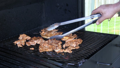 SmokingPit.com - Grilled Chicken Gyros with an authentic Greek Tzatziki sauce. Grilled over a Mesquite wood fire on the Scottsdale Santa Maria style cooker. Grilling the chicken.