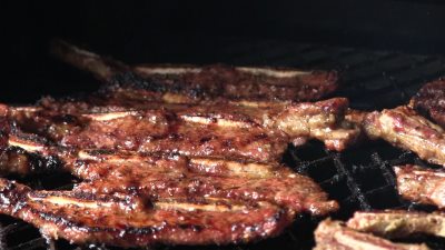 SmokingPit.com - Korean Kalbi BBQ Beef Short Ribs & Lobster Tails in a cajun butter sauce.le Santa Maria style  grill. -  Cooking the bacon.