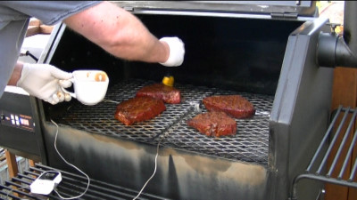 SmokingPit.com - Mesquite & Hickory Smoked Top Round Steak with Sauteed Mushrooms & Shrimp London Broil how to smoke cook videos on  slow cooking on the Yoder YS640 smoker & Traeger texas grill. - Mopping on the Big Moe's BBQ Sauce.