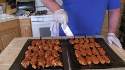 SmokingPit.com - Mad Hunky Italian Hot Wings. Slow cooked on the yoder YS640. Seasoning the chicken wings.