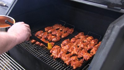 SmokingPit.com - Mad Hunky Italian Hot Wings. Slow cooked on the yoder YS640. Basting the chicken wings.