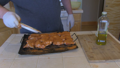 SmokingPit.com - Mad Hunky Tiger Sauce Hot Wings.  Slow cooked on the yoder YS640. Seasoniing the wings.