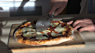 SmokingPit.com - Margherita Pizza recipe wood fire cooked on my Scottsdale Santa Maria style cooker. Slicing the pizza pie.