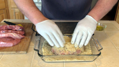 SmokingPit.com - Parmesan Encrusted Pork Loin Chops with fresh rosemary. Slow cooked on a Yoder YS640 Pellet cooker. Applying the breading & parmesan.