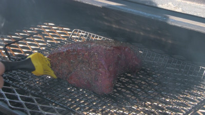 SmokingPit.com - Savory Beef Chuck Cross Rib Roast slow cooker on a Yoder YS640 Pellet cooker - Mopping the roast with garlic butter sauce.