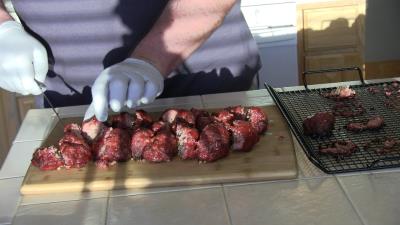 SmokingPit.com BBQ - Signature Apple Smoked Meatball Sub with a fresh tangy marinara. Slicing the meatballs.