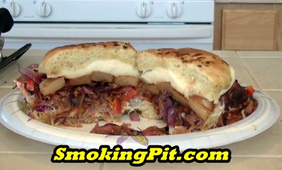 SmokingPit.com - The Ultimate Smoked BBQ Pulled Pork Sandwich sliced to show ingredients - Smoked on a Yoder YS640 -