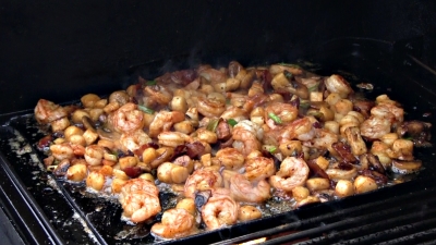 SmokingPit.com - Cajun Shrimp & Bay Scallops with a cajun butter sauce and mushrooms. Griddle cooked on a Yoder YS640 Pellet grill. Cooking the seafood.