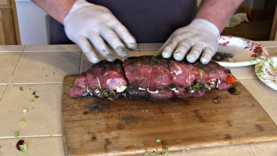 SmokingPit.com BBQ - Crimini Mushrooms, green onion, garlic sauteed in butter. Anaheim peppers and red peppers roasted. All this is stuffed into a tri tip with provolone cheese. Tying the roast.