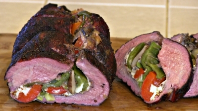 SmokingPit.com BBQ - Crimini Mushrooms, green onion, garlic sauteed in butter. Anaheim peppers and red peppers roasted. All this is stuffed into a tri tip with provolone cheese. Carving the roast.