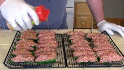 SmokingPit.com - Negra Modelo Infused Beef ABT's cooked on a Yoder YS640 Pellet Grill. Shaking on the rub.