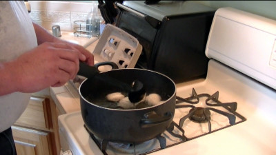 SmokingPit.com - Pickled Evil Eggs with cold smoked peppers, onion and garlc. Boiling eggs - Cooked on the Yoder YS640