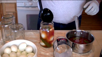 SmokingPit.com - Pickled Evil Eggs with cold smoked peppers, onion and garlc. Filling the jars - Cooked on the Yoder YS640