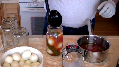 SmokingPit.com - Pickled Evil Eggs with cold smoked peppers, onion and garlc. Filling the jars - Cooked on the Yoder YS640