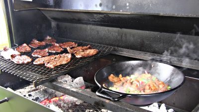 SmokingPit.com - Sesame Soy thin  sliced Beef Bottom Round Steak with a shrimp stirfry. Beef is cooked on a Santa Maria style  grill. Stir fry is done on a Wok in the grill. -  Cooking on the Scottsdale.